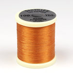 Close-up of 140 Denier Danville thread from Clouser's Fly Shop, showing the dark brown spool with tightly wound thread.