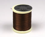 Close-up of 140 Denier Danville thread from Clouser's Fly Shop, showing dark brown thread on a spool for fly tying.