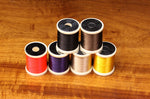 Close-up of 140 Denier Danville thread spool from Clouser's Fly Shop, showing dark brown thread on a white background.