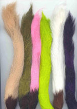 Close-up of a calf tail used as fly tying material, showcasing natural hair texture and color for fishing fly creation.