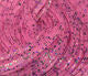 Close-up of Crazy Legs fly tying material by Clouser's Fly Shop, showing shiny, segmented synthetic legs for fishing flies.