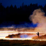 Foggy scene with a dozen Griffiths Gnat Midge trout dry flies in size 20, used for fly fishing, displayed on a fishing scene.