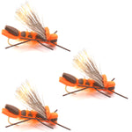 Three orange Godzilla hopper foam flies for trout fishing, size 10, by The Fly Fishing Place, with realistic grasshopper and salmonfly details.