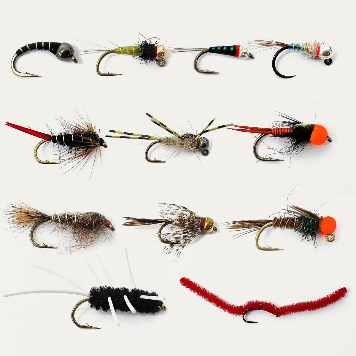 Collection of variously designed fishing flies on a white background