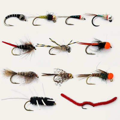 Collection of variously designed fishing flies on a white background