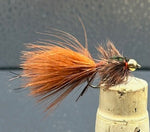 Fishing fly on a cork bobber against a gray background