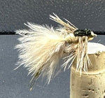Fly fishing fly on a cork stopper against a dark background