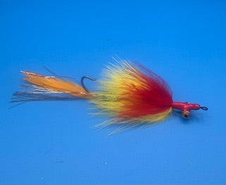 Red and yellow fly fishing lure on a blue background