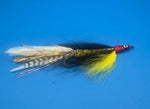 Fishing fly with red head and white body on a blue background