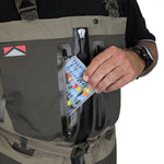 Person opening a backpack with a compartment containing fishing lures.
