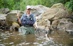 Woman trout fishing in mountain stream with Black Zebra Midge wet flies, size 22, from The Fly Fishing Place for tailwater and lake fishing