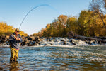 Three size 14 chartreuse mop tungsten bead jig trout wet flies for fly fishing, displayed near a waterfall.
