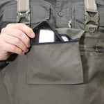 Person placing a smartphone into a pocket of gray tactical pants.