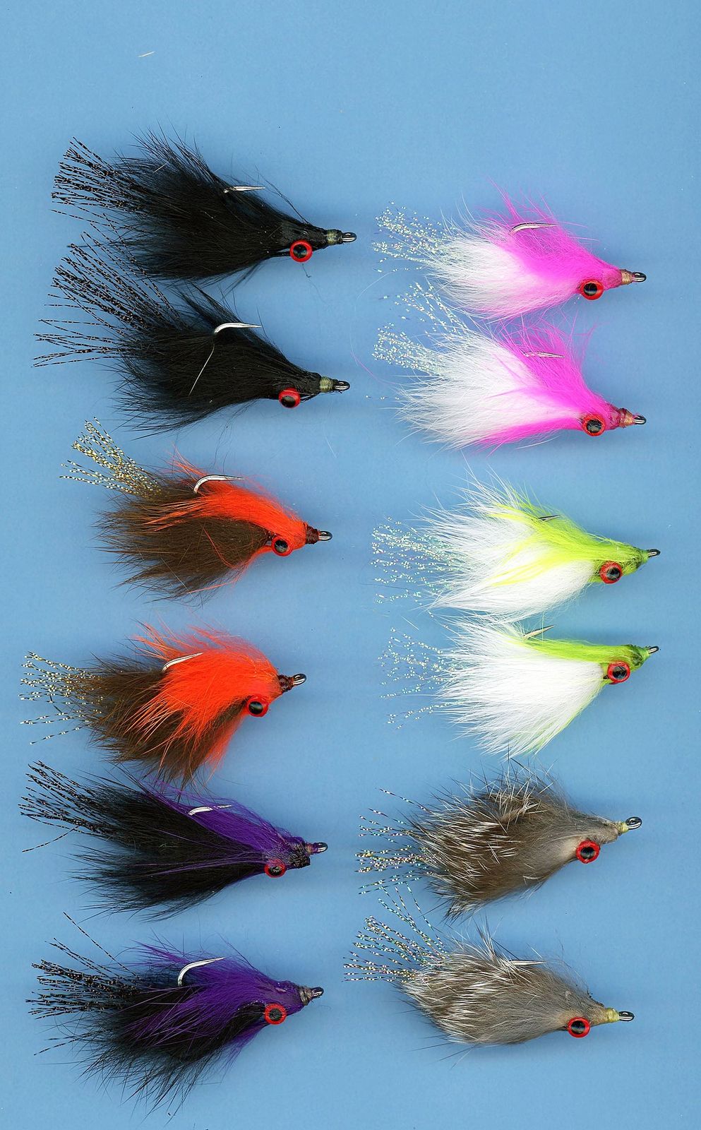 Assorted Clouser's JP Crosscut Minnow flies in various colors and sizes, designed for fishing at Clouser's Fly Shop.