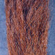 Clouser's Fly Shop calf tail used as fly tying material, showing soft, natural hair suitable for fishing lures.