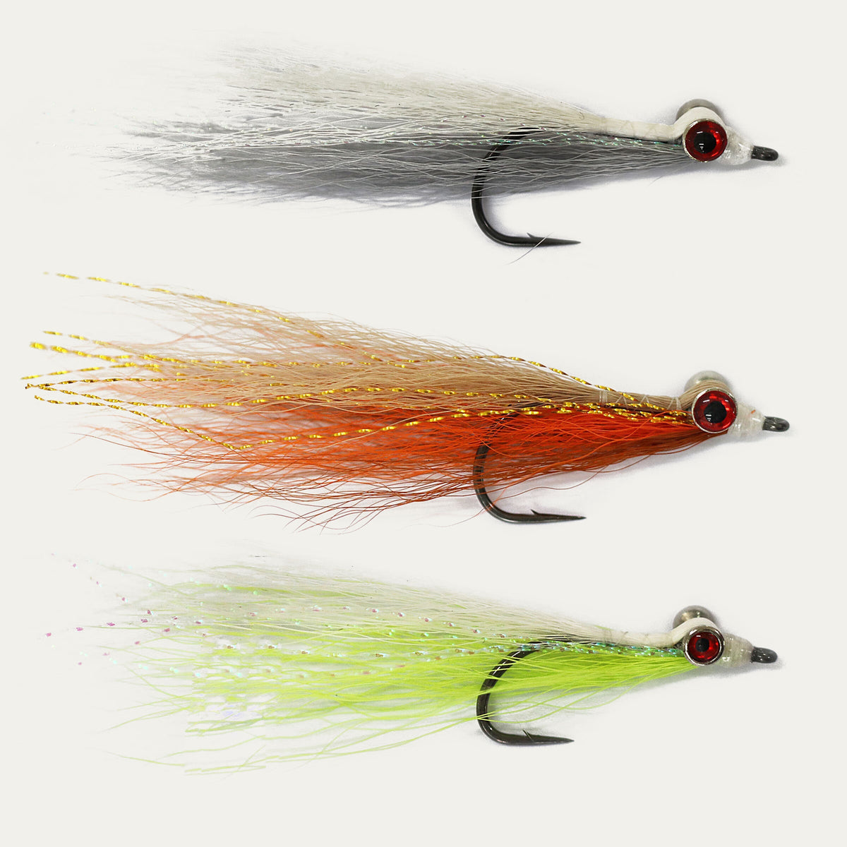 Three fishing lures with different colors on a white background
