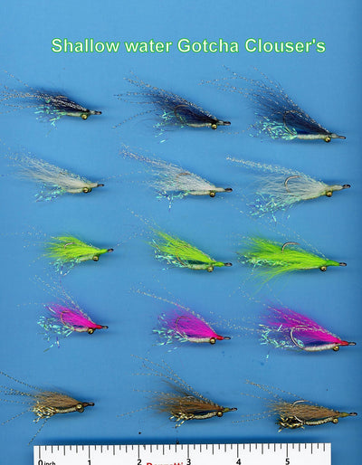 Close-up of Gotcha Clousers fishing flies by Clouser's Fly Shop, showcasing their colorful feather and hook design for fly fishing.