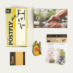 Postfly Trout Fly Tying Kit box with various fly tying materials and tools for freshwater trout fishing.