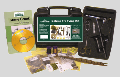 Stone Creek Deluxe Fly Tying Kit with tools and materials on a gray background