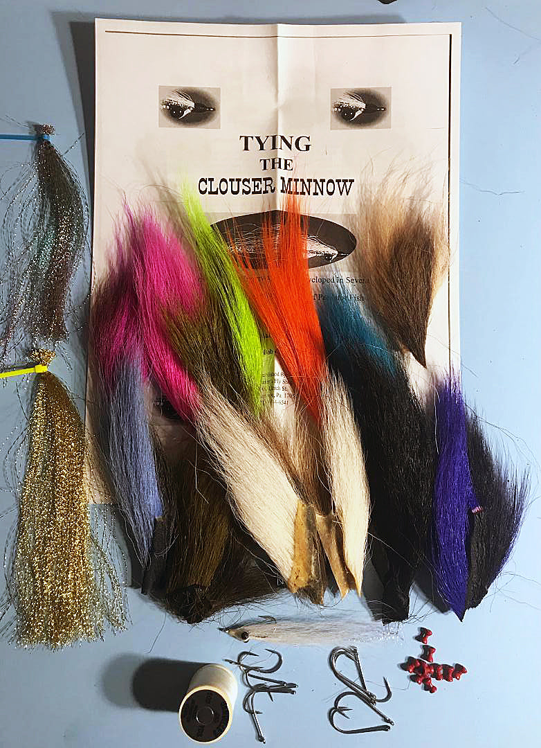 Clouser's Deep Minnow Kit fly tying materials with hooks, feathers, and thread for creating deep minnow fishing flies.